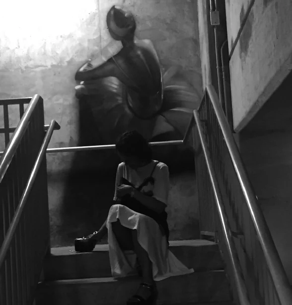 Nisha Inalsingh seated on a stairwell